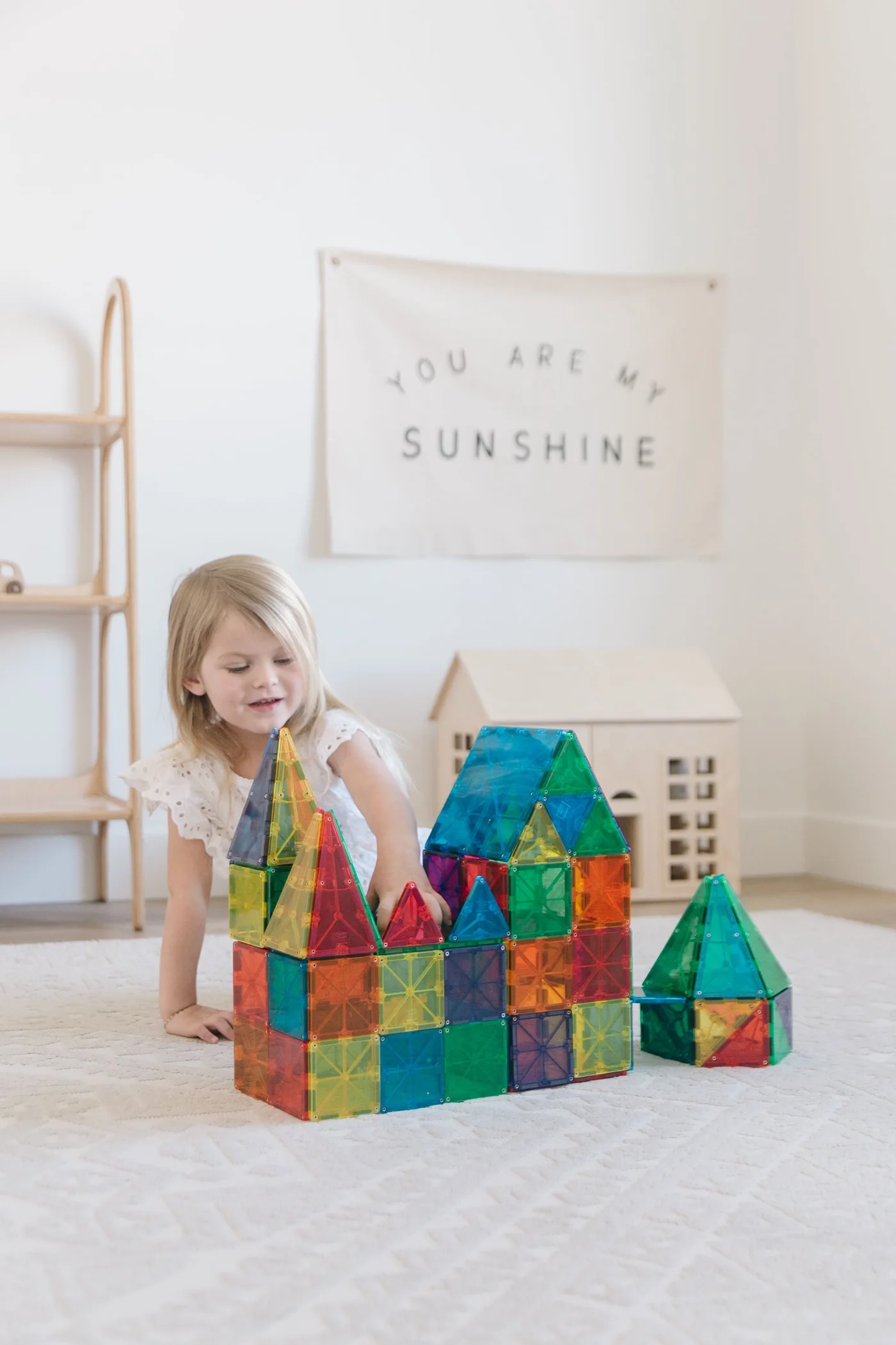 A child building with colorful MAGNA-TILES in a bright playroom